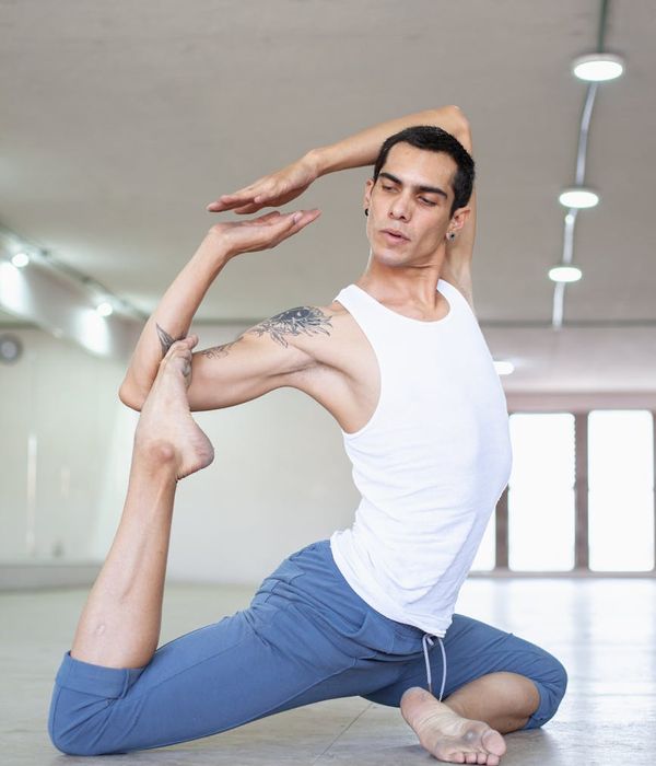 Man performing a controlled strength exercise in a minimalist setting.
